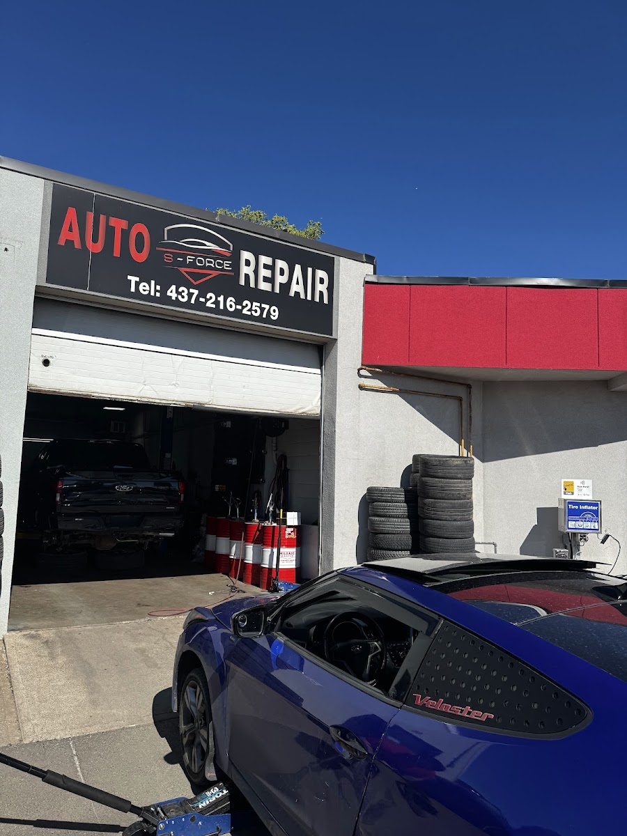 S Force Auto Repair shopfront with bay door open and vehicles inside